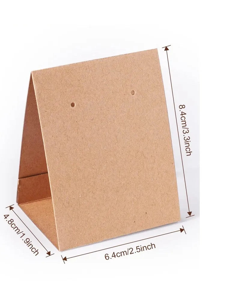 A brown cardboard display stand with dimension markings showing its height of 8.4cm (3.