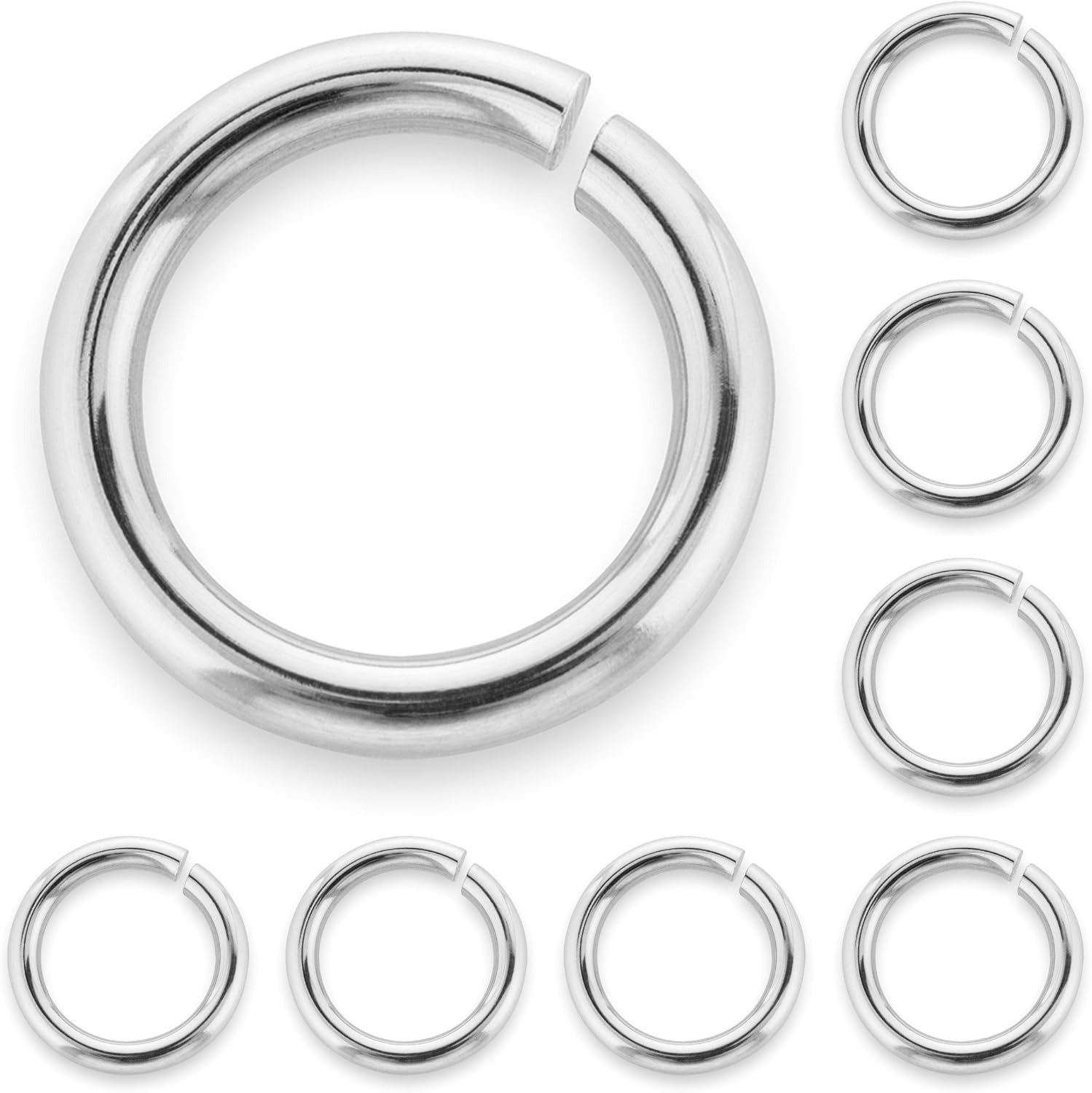 A set of polished sterling silver jump rings with one large one shown on the left and five smaller ones arranged vertically on the right and horizontally along the bottom, all on a plain white background.