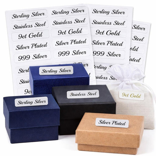 Set of jewelry boxes with labels indicating metal type on a white background